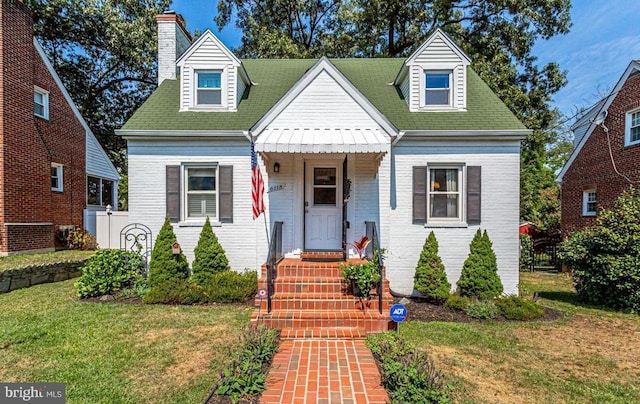 cape cod house with a front yard