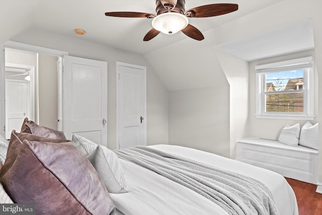 bedroom featuring ceiling fan, vaulted ceiling, and dark hardwood / wood-style flooring