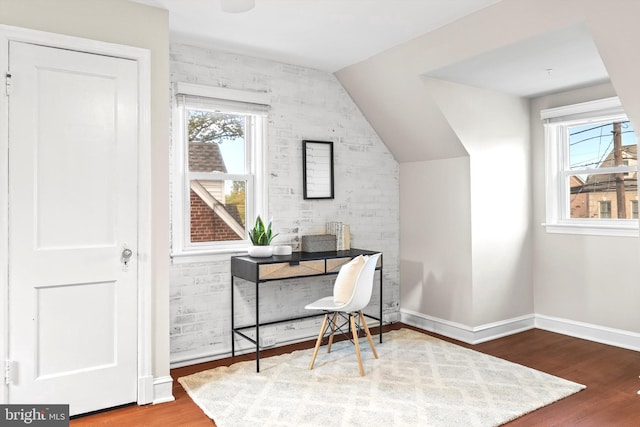 office with a healthy amount of sunlight, lofted ceiling, and hardwood / wood-style flooring