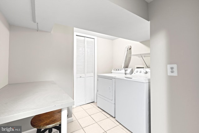 clothes washing area with light tile floors, hookup for a washing machine, and washer and clothes dryer