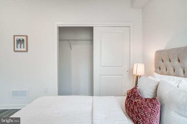 bedroom with a closet and hardwood / wood-style floors