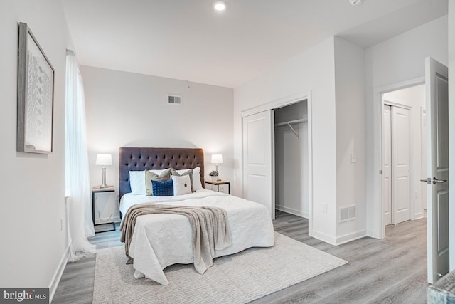 bedroom featuring a closet and light wood-type flooring