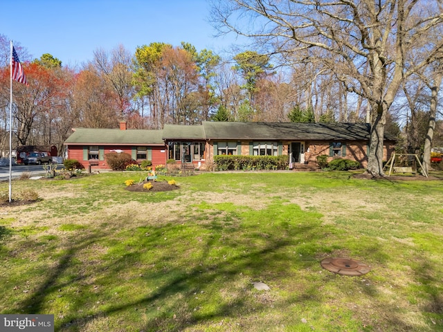 rear view of property featuring a yard