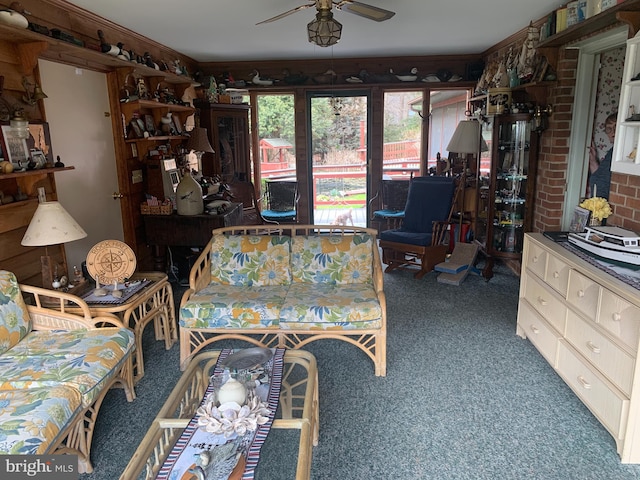 living room featuring dark carpet and ceiling fan