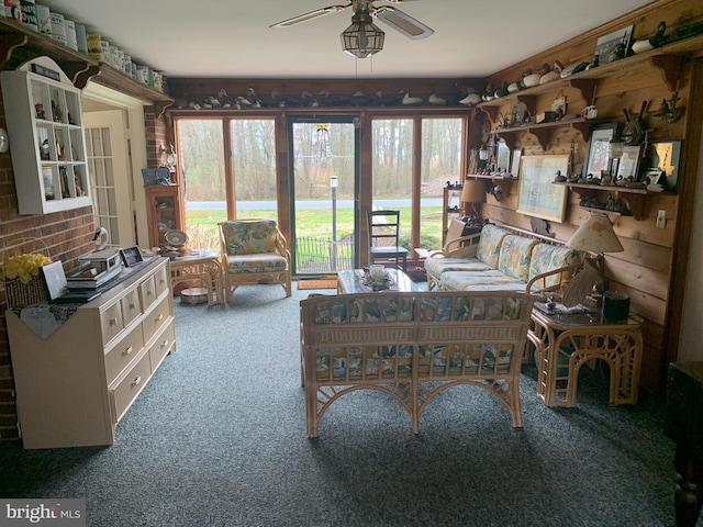 living room with ceiling fan and dark carpet