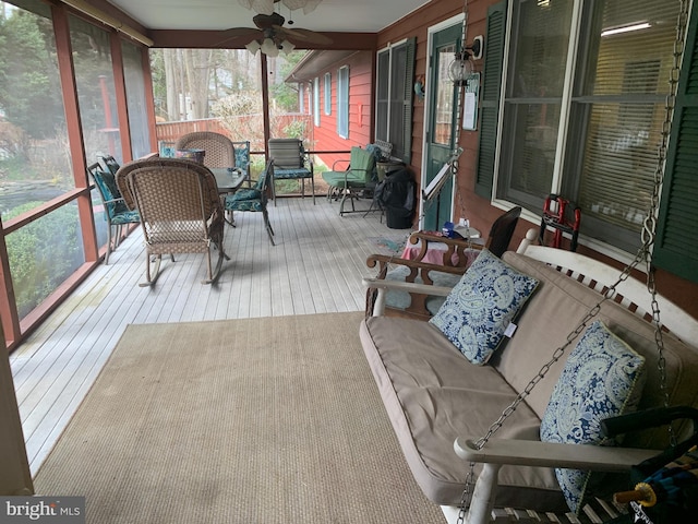 sunroom featuring a healthy amount of sunlight and ceiling fan