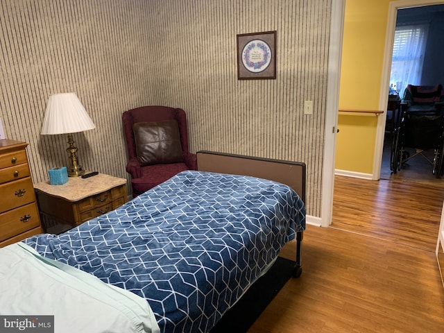 bedroom with dark hardwood / wood-style floors