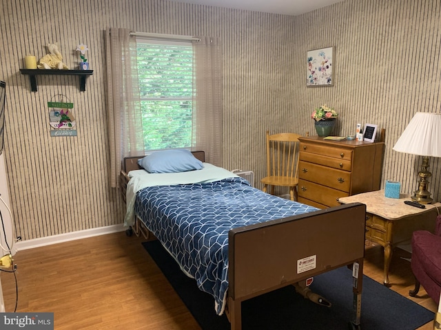 bedroom featuring dark hardwood / wood-style flooring