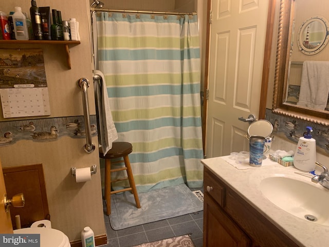 bathroom with oversized vanity, toilet, and tile floors