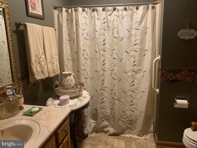 bathroom with toilet, tile floors, and vanity