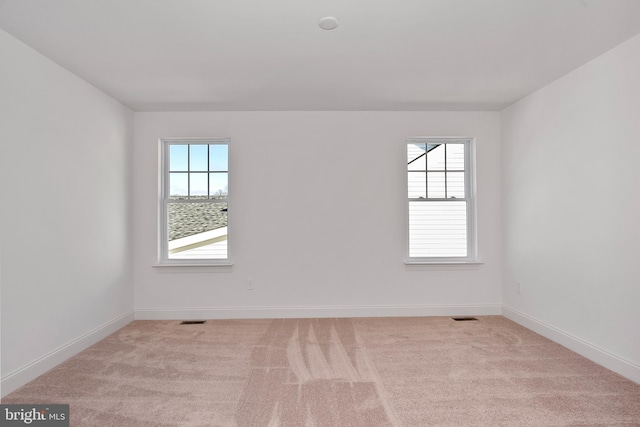 spare room with light colored carpet