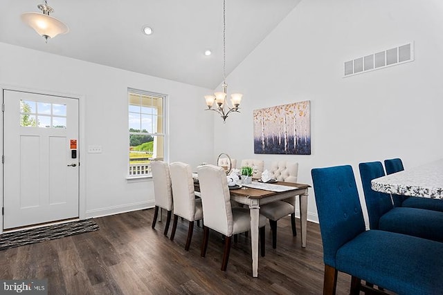 dining area with a notable chandelier, dark wood-type flooring, and high vaulted ceiling