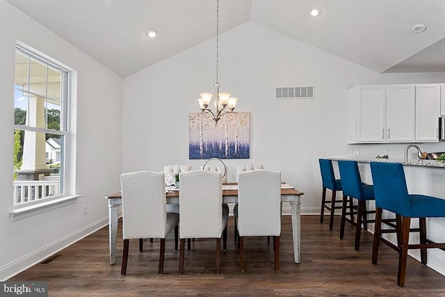 dining space with high vaulted ceiling, an inviting chandelier, dark hardwood / wood-style flooring, and sink