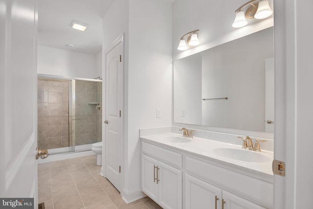 bathroom with toilet, dual bowl vanity, tile flooring, and walk in shower