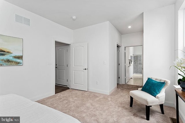 carpeted bedroom featuring ensuite bathroom