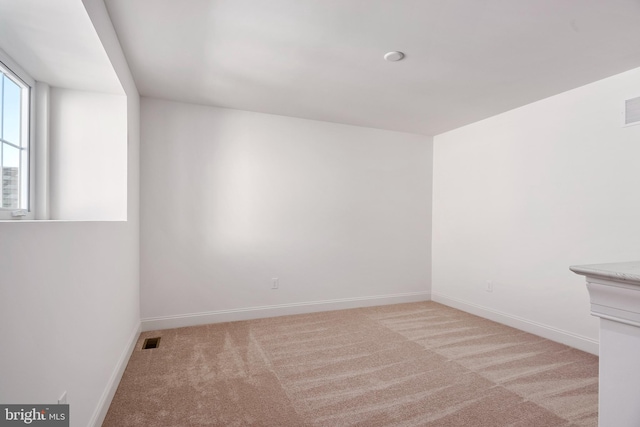 unfurnished room featuring light colored carpet