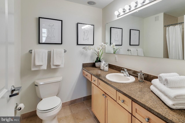 bathroom featuring oversized vanity, tile flooring, and toilet