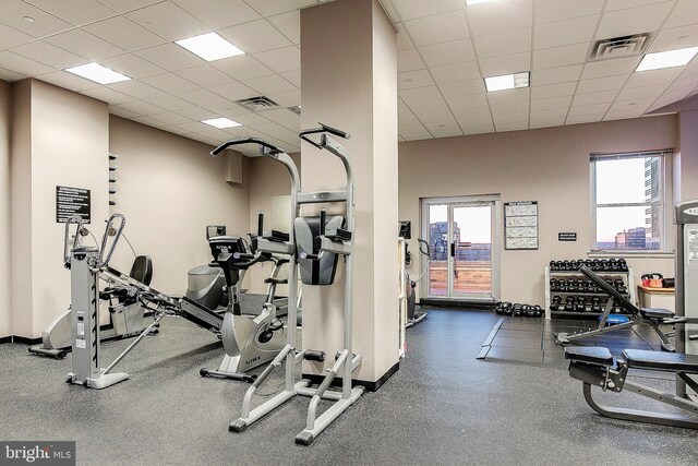 workout area with a paneled ceiling