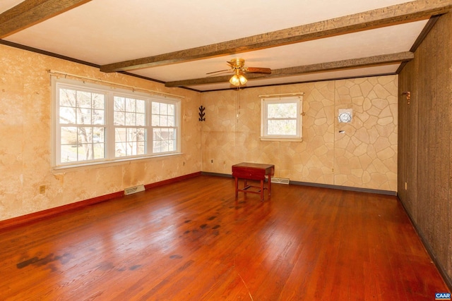 spare room featuring dark hardwood / wood-style flooring, ceiling fan, and beam ceiling