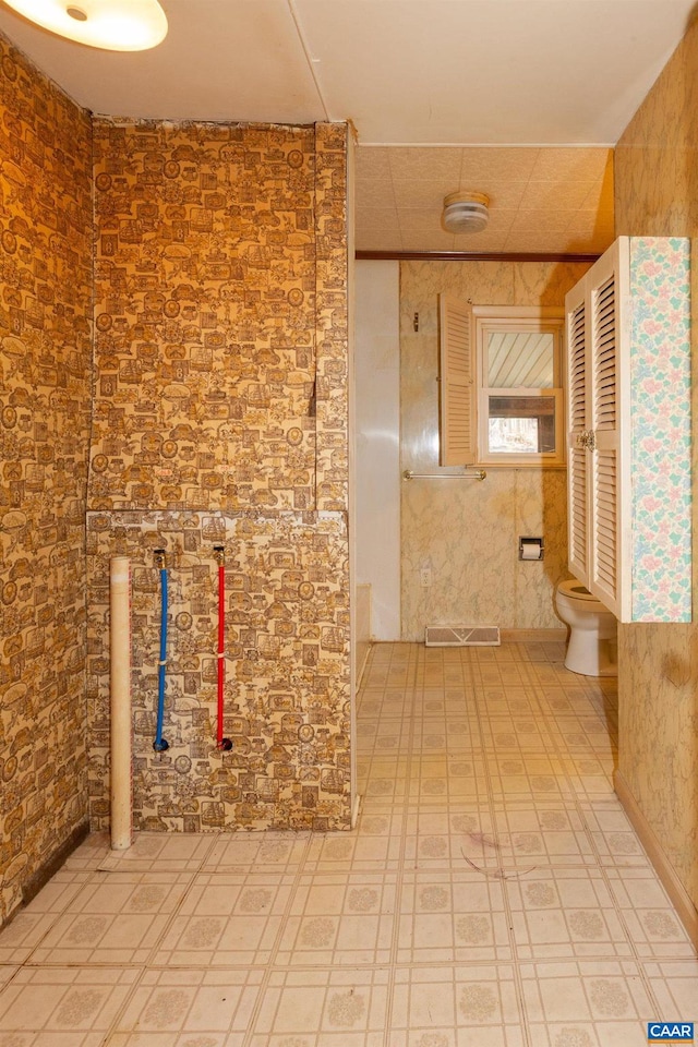 interior space featuring toilet and tile floors