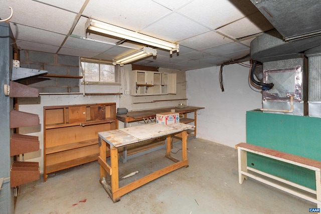 basement with a paneled ceiling