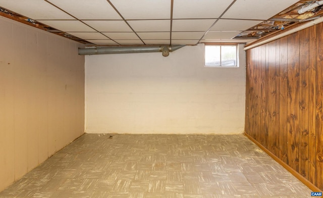 basement with a paneled ceiling