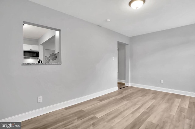 spare room featuring light hardwood / wood-style flooring