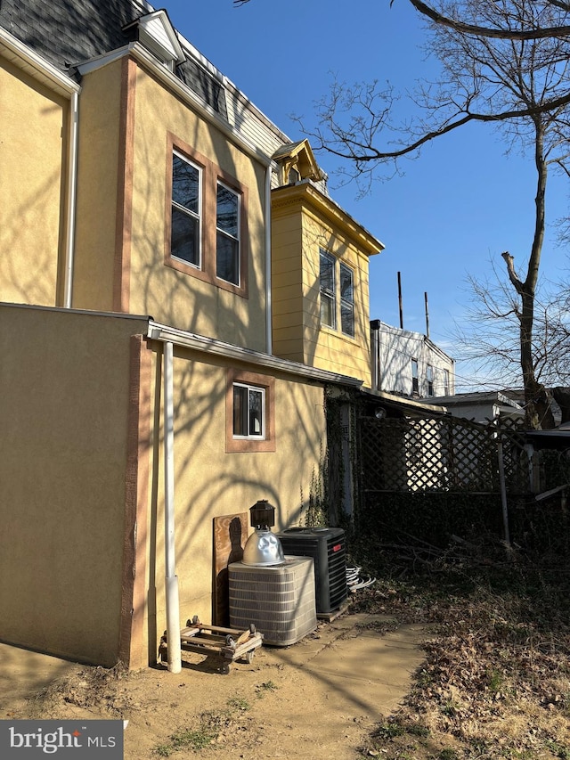 back of property with central AC unit