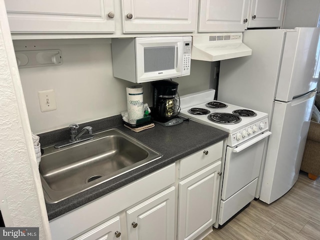 kitchen featuring custom range hood, sink, white appliances, and white cabinetry