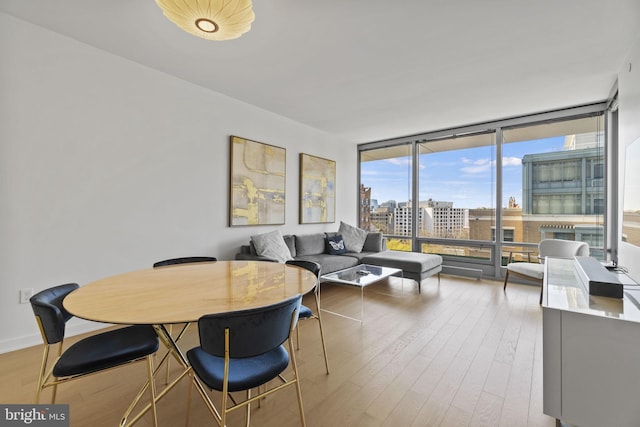 dining room with expansive windows and wood-type flooring