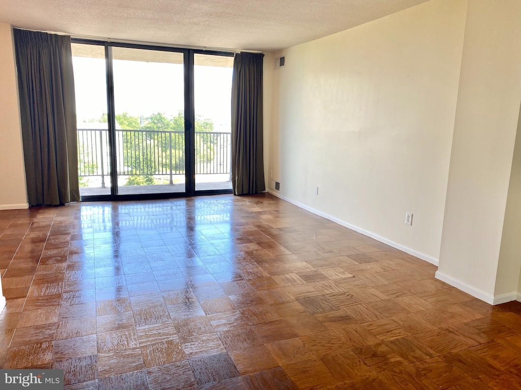 spare room featuring expansive windows