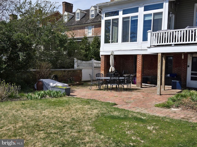 rear view of house with a patio area and a lawn