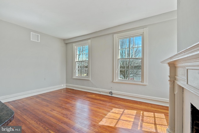 unfurnished living room featuring a fireplace and wood-type flooring