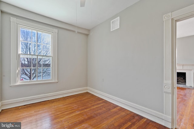 unfurnished room featuring ceiling fan and wood-type flooring