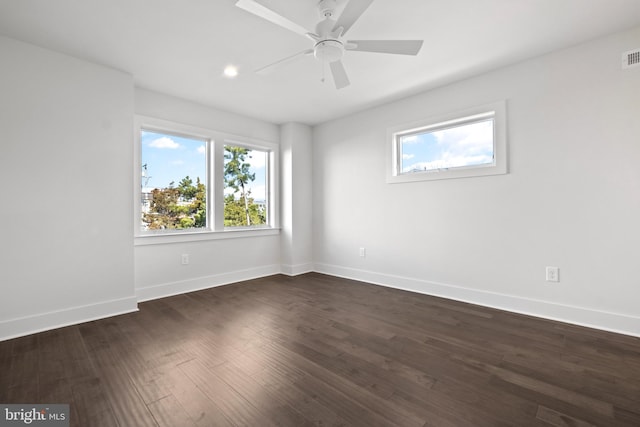 empty room featuring dark hardwood / wood-style flooring and ceiling fan