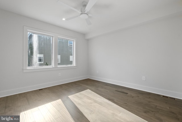 spare room featuring ceiling fan and dark hardwood / wood-style flooring