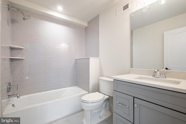 full bathroom featuring tile patterned floors, toilet, vanity, and tiled shower / bath