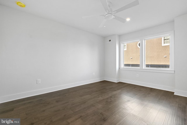 unfurnished room with ceiling fan and dark hardwood / wood-style floors