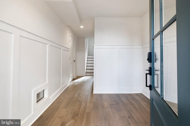 hallway with hardwood / wood-style floors