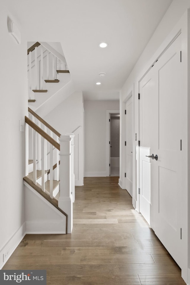 hall with hardwood / wood-style floors