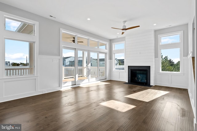 unfurnished living room with a fireplace and dark wood-type flooring