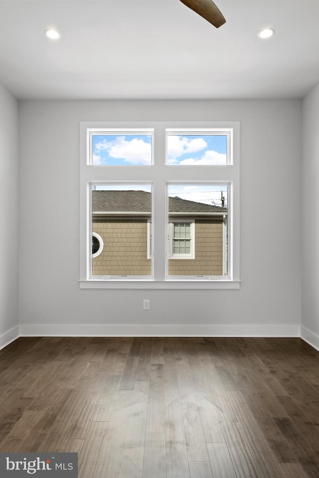 unfurnished room featuring dark hardwood / wood-style floors and ceiling fan