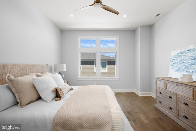 bedroom with dark hardwood / wood-style floors and ceiling fan