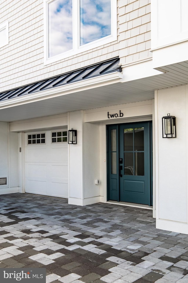 view of exterior entry featuring a garage