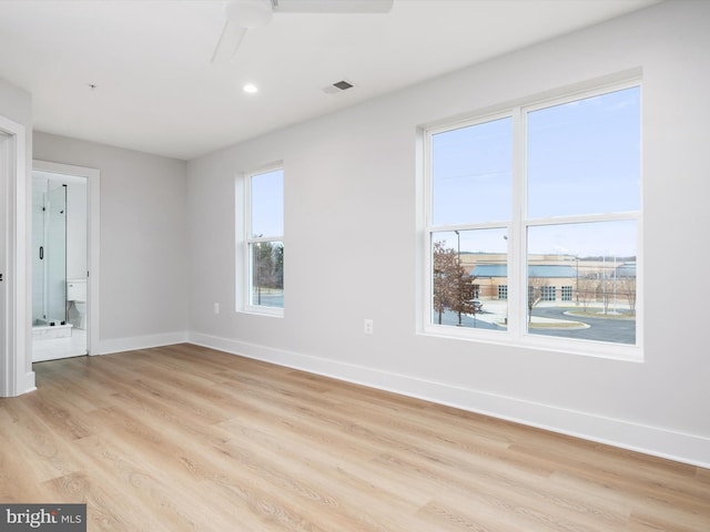 empty room with light wood-type flooring and ceiling fan