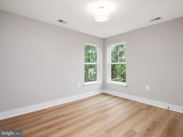 spare room featuring light wood-type flooring