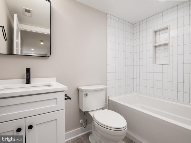 full bathroom with tiled shower / bath, vanity, toilet, and tile patterned floors