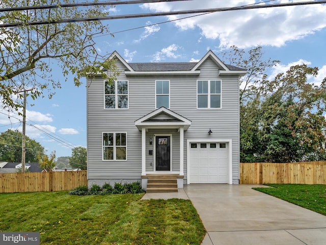 view of front of home with a front yard and a garage