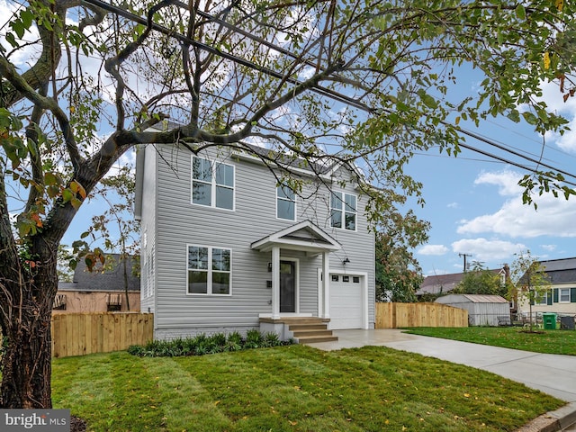 view of front of property with a garage and a front lawn