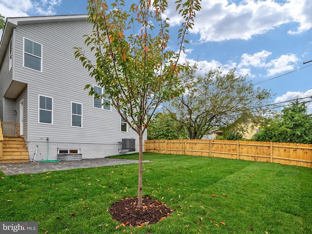 view of yard featuring a patio and central air condition unit